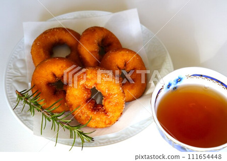 Donuts and tea on a plate, tea time Donuts and tea on a plate, tea time 111654448
