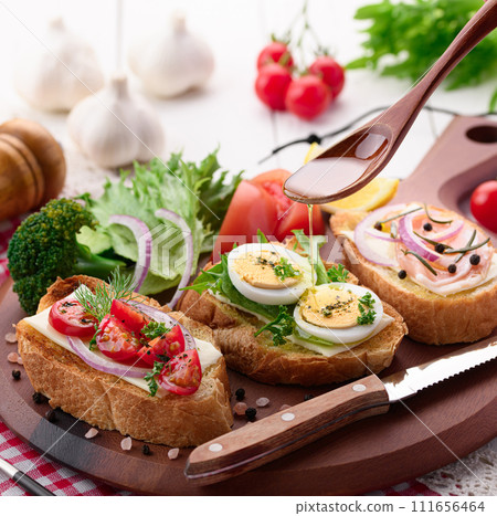 將橄欖油倒在義式烤麵包上 將橄欖油倒在義式烤麵包上 111656464