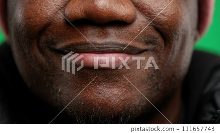 Man's mouth, close-up, on a green background Man's mouth, close-up, on a green background 111657743