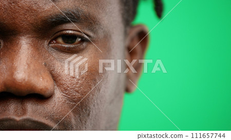 Man's face, close-up, on a green background 111657744