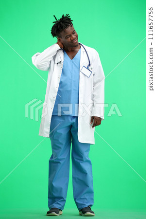 The doctor, in full height, on a green background, tired 111657756