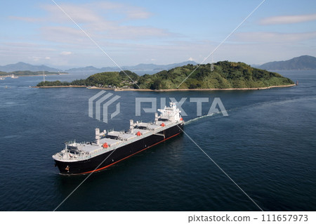 Cargo ship passing Kurushima Strait Bridge 111657973