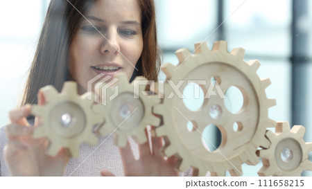 A woman in close-up in the office is thinking over a complex business plan 111658215