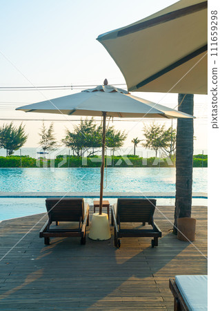 umbrella with bed pool around swimming pool with ocean sea background 111659298