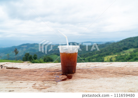 americano coffee on wood table with Mountain hill View background 111659480