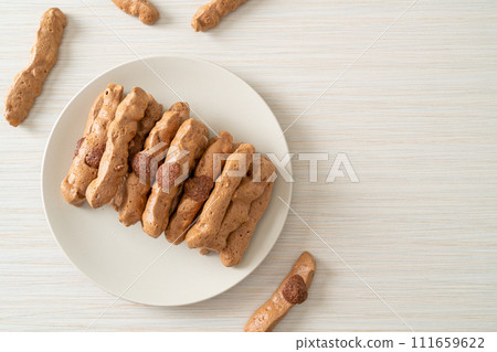 chocolate meringue stick on plate 111659622