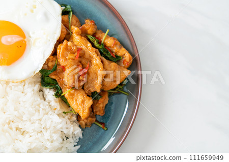 stir-fried fried fish with basil and fried egg topped on rice stir-fried fried fish with basil and fried egg topped on rice 111659949