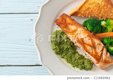 grilled salmon steak with pesto sauce grilled salmon steak with pesto sauce 111660462