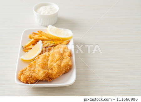 fish and chips - fried fish fillet with potatoes chips fish and chips - fried fish fillet with potatoes chips 111660990