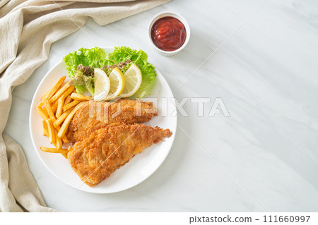 Homemade Breaded Weiner Schnitzel with Potato Chips 111660997