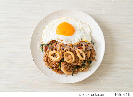 fried rice with squid and basil topped fried egg in Thai style 111661646