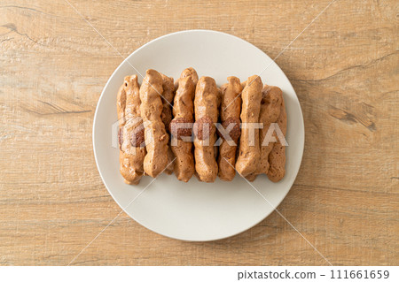 chocolate meringue stick on plate 111661659