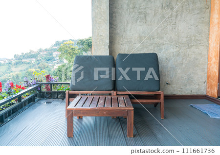 chair on balcony with mountain hill background chair on balcony with mountain hill background 111661736