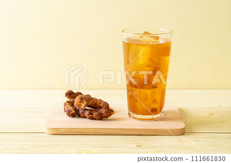 Delicious sweet drink tamarind juice and ice cube 111661830