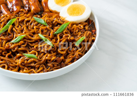 Jjajang Rabokki - Korean instant noodles or Ramyeon with Korean rice cake or Tteokbokki and egg in black bean sauce 111661836