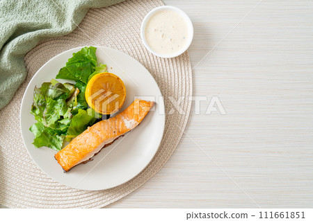 fried salmon steak with lemon and vegetable 111661851