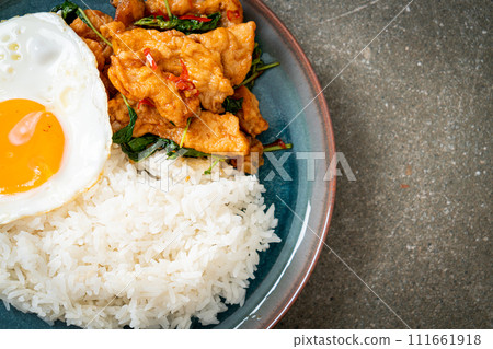 stir-fried fried fish with basil and fried egg topped on rice stir-fried fried fish with basil and fried egg topped on rice 111661918