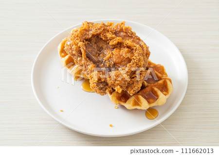 fried chicken waffle with honey or maple syrup 111662013