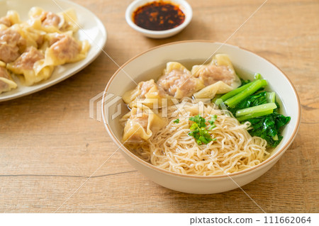 egg noodles with pork wonton soup or pork dumplings soup and vegetable 111662064