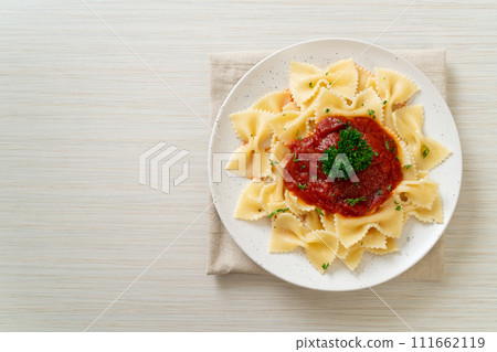 farfalle pasta in tomato sauce with parsley farfalle pasta in tomato sauce with parsley 111662119