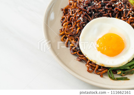 dried Korean spicy black sauce instant noodles with fried egg and kimchi dried Korean spicy black sauce instant noodles with fried egg and kimchi 111662161