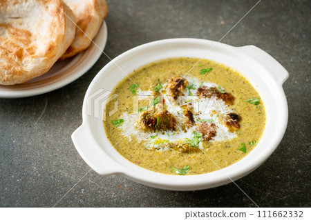 Afghani chicken in green masala curry or Hariyali tikka chicken hara masala with roti or naan bread Afghani chicken in green masala curry or Hariyali tikka chicken hara masala with roti or naan bread 111662332