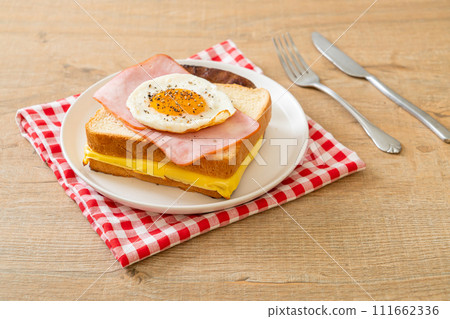 bread toasted cheese topped ham and fried egg with pork sausage bread toasted cheese topped ham and fried egg with pork sausage 111662336