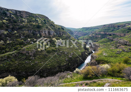 Panoramic view of Aksu canyon with a river in rocks in spring in Kazakhstan 111663675