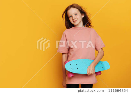 Young Woman with Skateboard on Yellow Background 111664864
