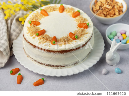 Homemade Easter carrot cake made with walnuts, iced with cream cheese. Sweet dessert. Homemade Easter carrot cake made with walnuts, iced with cream cheese. Sweet dessert. 111665620