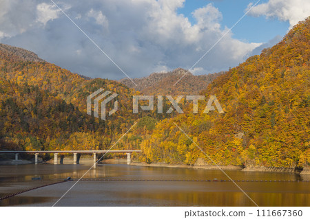 Japan: Lake Sapporo, an artificial lake created by Jozankei Dam in Minami Ward, Sapporo City, Hokkaido, and autumn leaves 111667360
