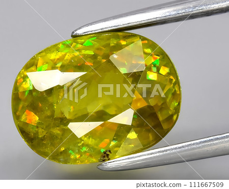 natural yellow sphene titanite gem on the background natural yellow sphene titanite gem on the background 111667509