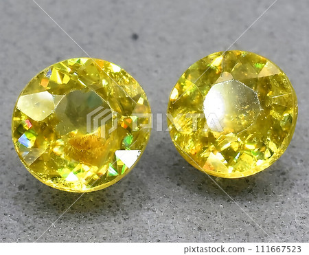natural yellow sphene titanite gem on the background 111667523