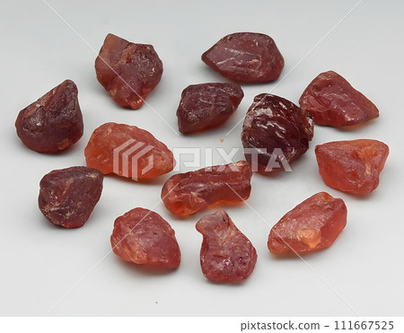 natural orange spessartite garnet rough gem on the background 111667525
