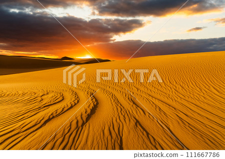 Sunset over the sand dunes in the desert. Sahara desert 111667786