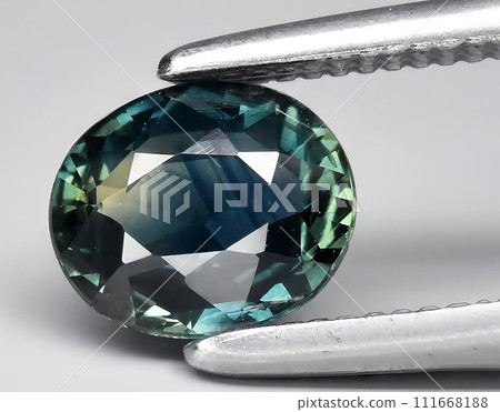 natural green blue sapphire gem on the background 111668188