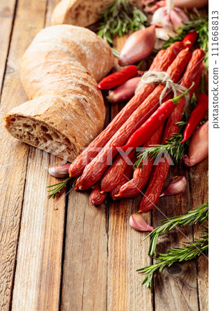 Smocked sausages with onion, garlic, pepper, and rosemary. Smocked sausages with onion, garlic, pepper, and rosemary. 111668813