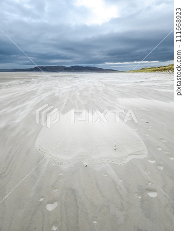 Sand storm forming a tulip at Dooey beach by Lettermacaward in County Donegal - Ireland 111668923
