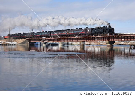 A steam locomotive crossing the Kushiro River iron bridge in sunny Hokkaido A steam locomotive crossing the Kushiro River iron bridge in sunny Hokkaido 111669038