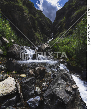 Waterfall in mountain river in a gorge in Aksu-Jabagly Nature Reserve in Kazakhstan in summer Waterfall in mountain river in a gorge in Aksu-Jabagly Nature Reserve in Kazakhstan in summer 111669415