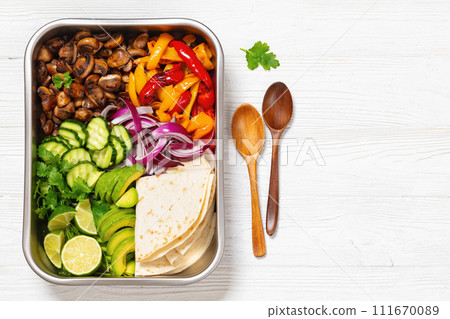 vegan fajitas with mushrooms, veggies on sheet pan 111670089
