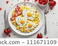 Valentine's Day breakfast - heart-shaped scrambled eggs. 111671109