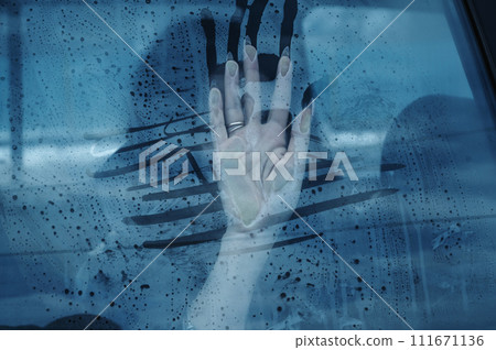 Concept of illegal kidnapping, trafficking and slavery. Woman girl female hand on car window for help and rescue from kidnapper 111671136