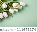 Beautiful white tulips in craft paper on green pastel background with copy space, spring time, mother's day 111671174