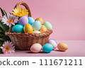 Basket with colorful Easter eggs and blooming flowers on the table on pink background. 111671211
