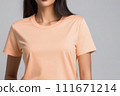 Woman in peach fuzz colored tshirt, can be used for design, mock up. The trending color of 2024. 111671214