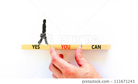 Motivational and Yes you can symbol. Concept words Yes you can on beautiful wooden blocks. Beautiful white background. Businessman hand. Business motivational and Yes you can concept. Copy space. 111671243