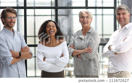 A group of young modern people in smart casual clothes, studying while working in the office 111672027