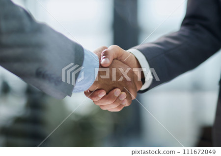 Businessman handshake for teamwork of business merger and acquisition Businessman handshake for teamwork of business merger and acquisition 111672049