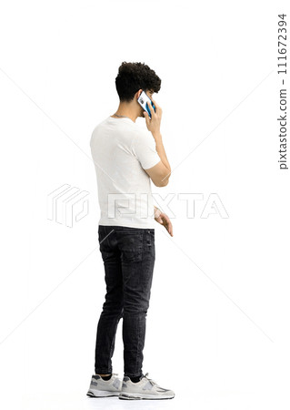 A man, on a white background, in full height, with a phone A man, on a white background, in full height, with a phone 111672394